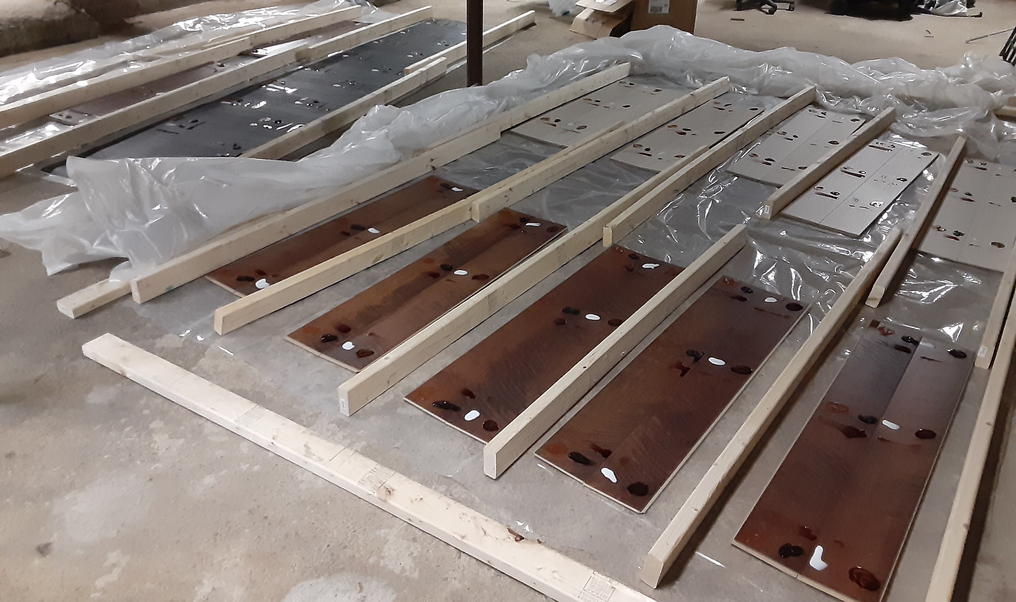 different types of hardwood floor panels lined up with stains on them, ready to be tested