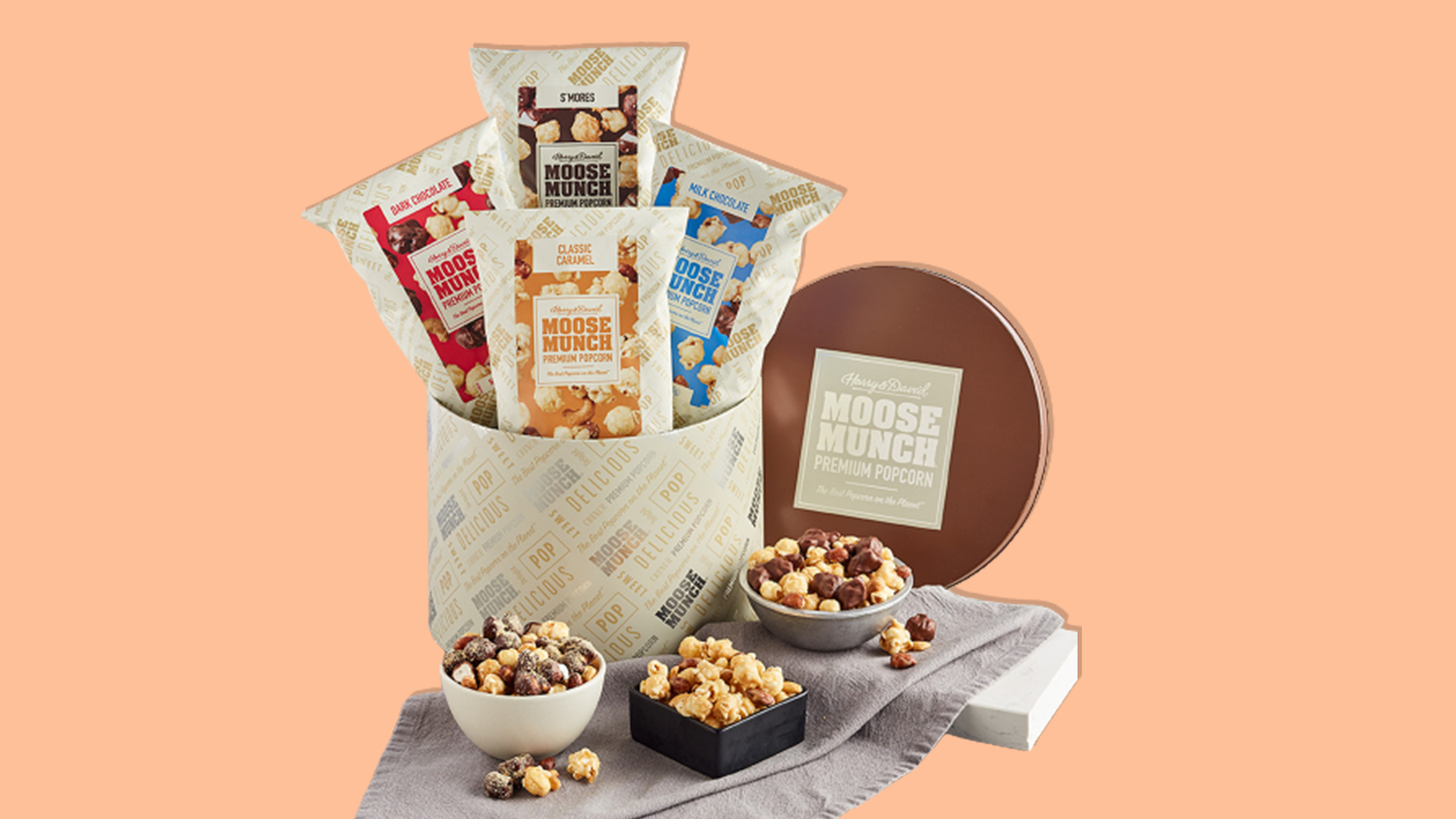 Moose Munch Premium Popcorn Classic Tin on an orange background.