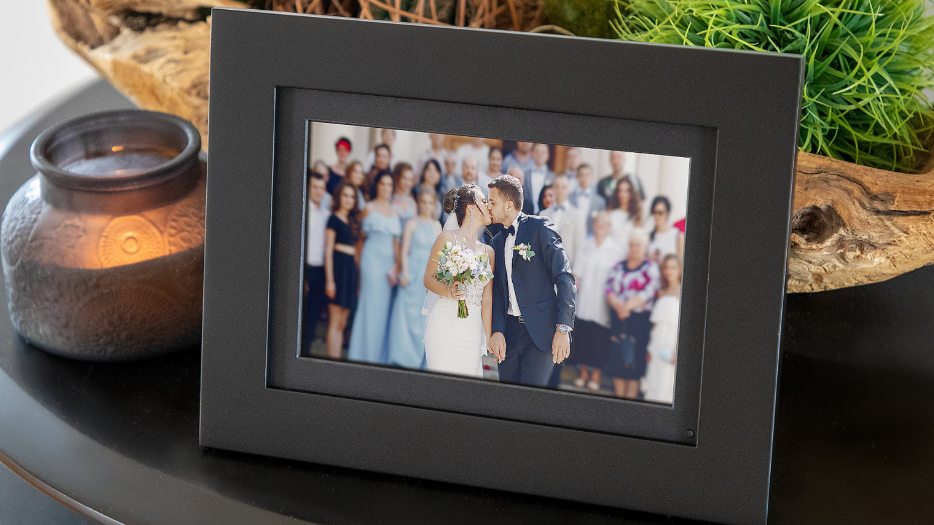 A digital photo frame displays a wedding day photo.