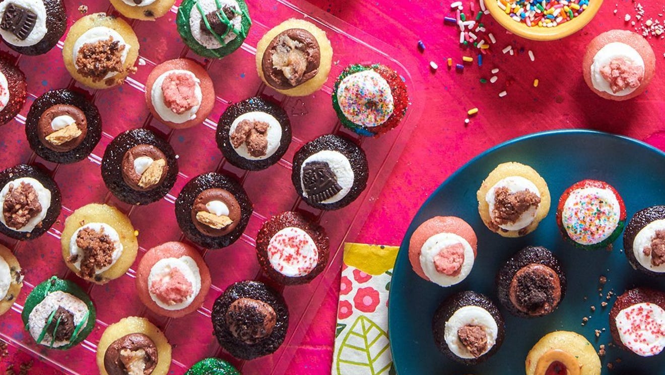 multiple cupcakes on a pink table