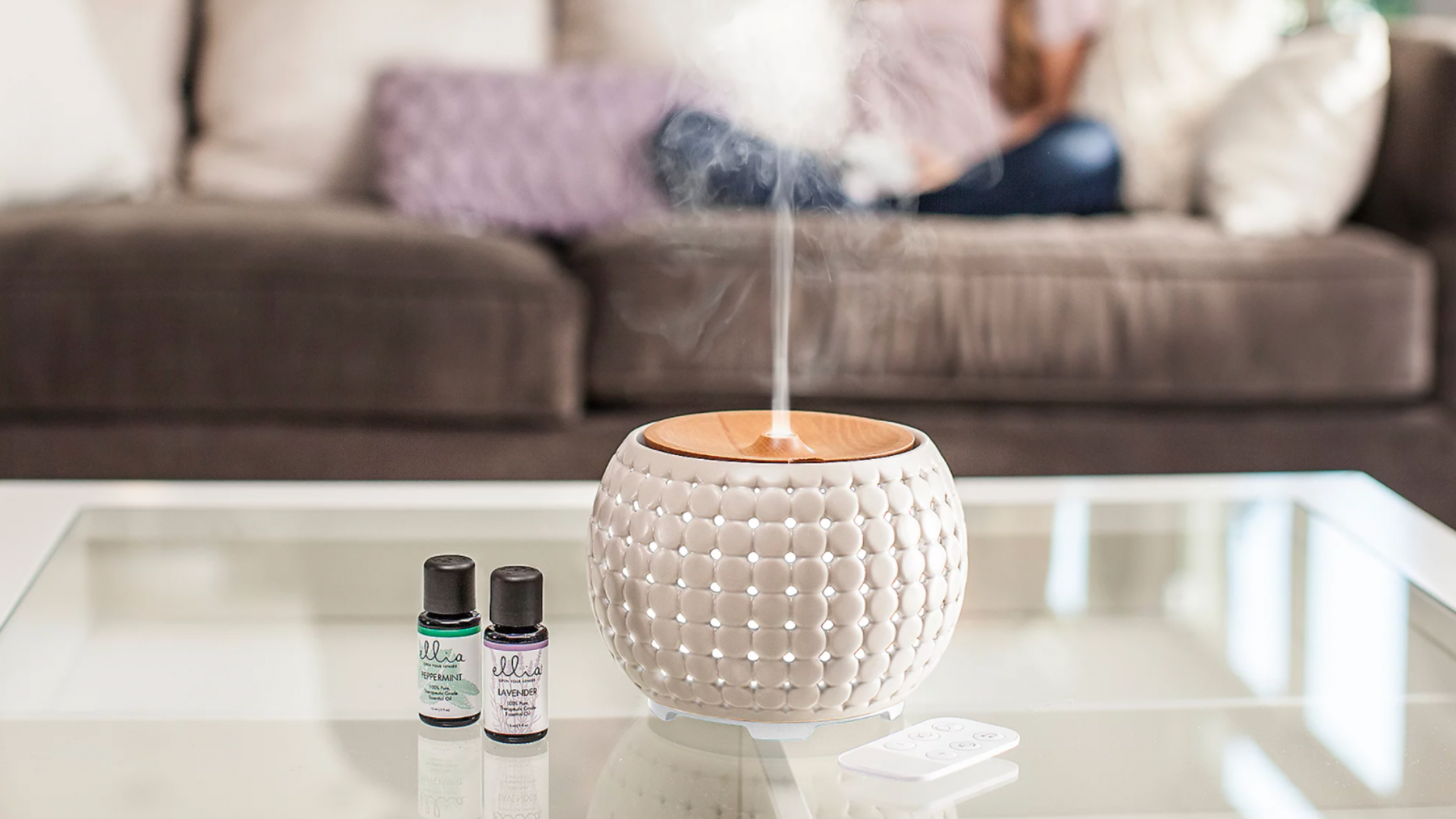 A room diffuser releases vapor in a living room.