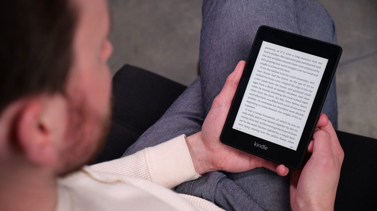 A person reading a Kindle.